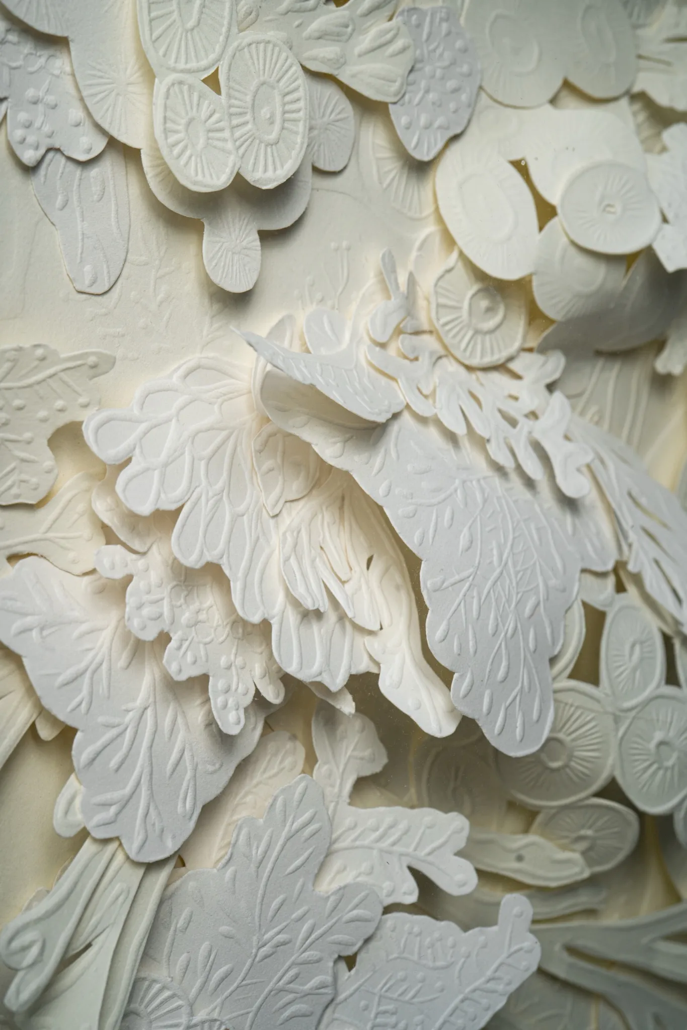Detail of Mar Blanco. Feathery fronds sweep across the middle of the sheet between clusters of embossed discs.